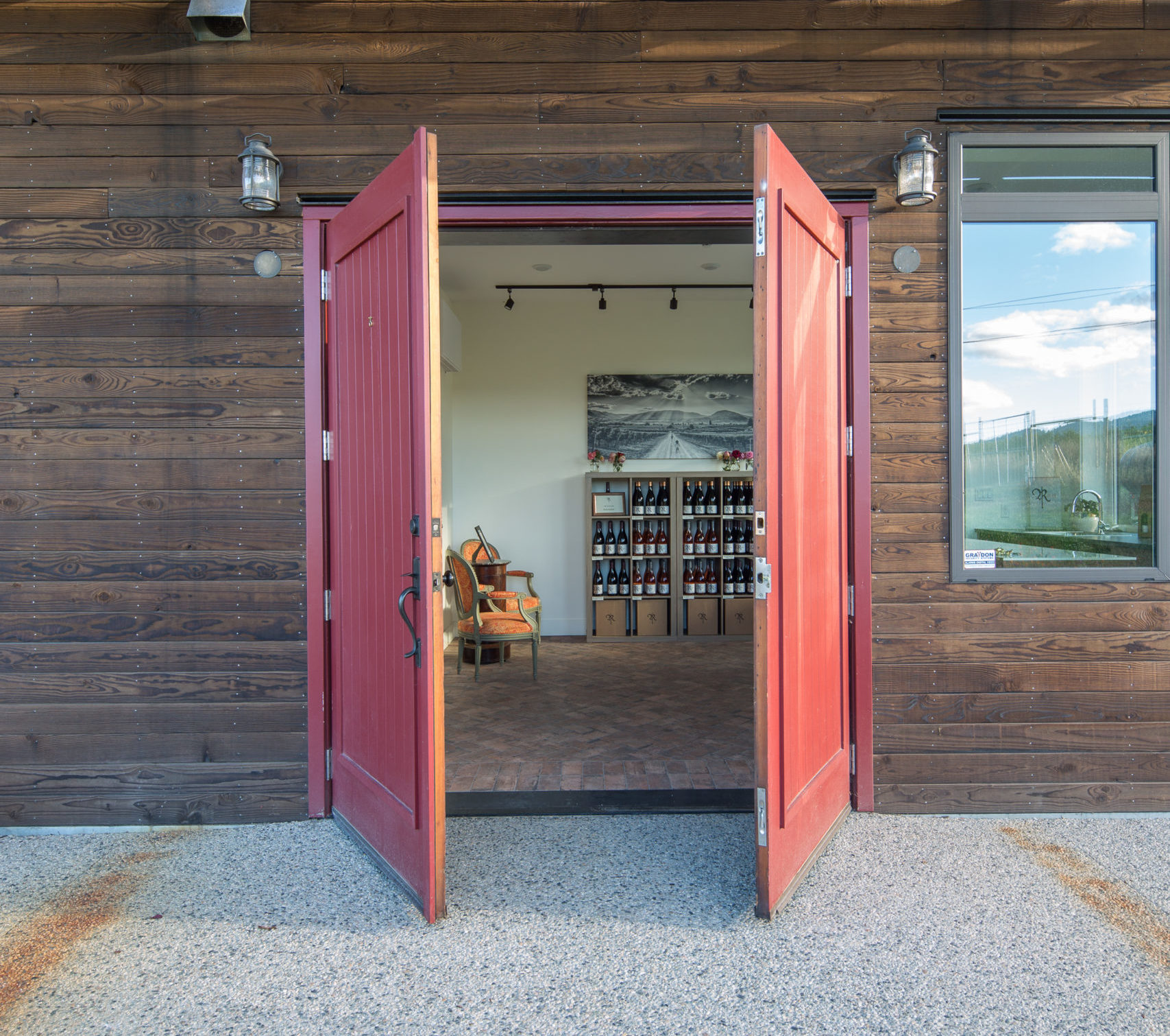 Red large barn style doors opening into the Roche Tasting room.